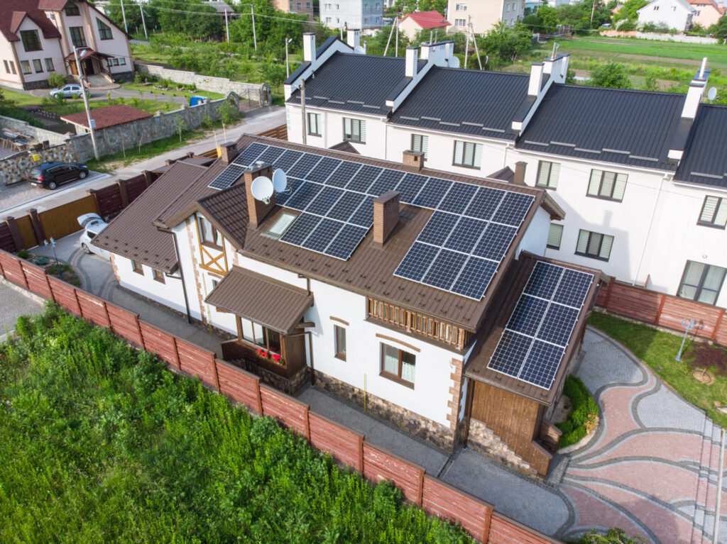 Modern house with rooftop residential solar panels installed for sustainable energy and lower electricity costs.