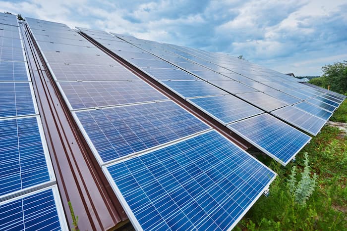 Solar panels on rooftop generating renewable energy – sustainable solar power system installation for homes and businesses.