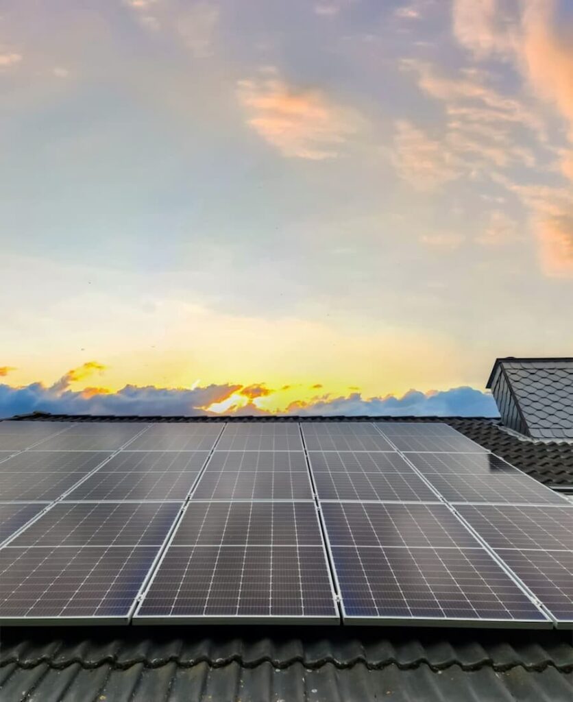 Residential solar rooftop system generating clean energy during sunset.