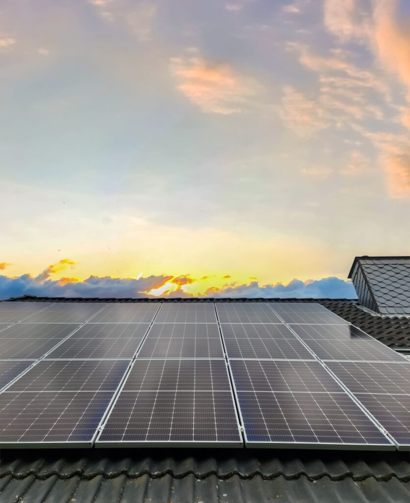 Residential solar rooftop system generating clean energy during sunset.